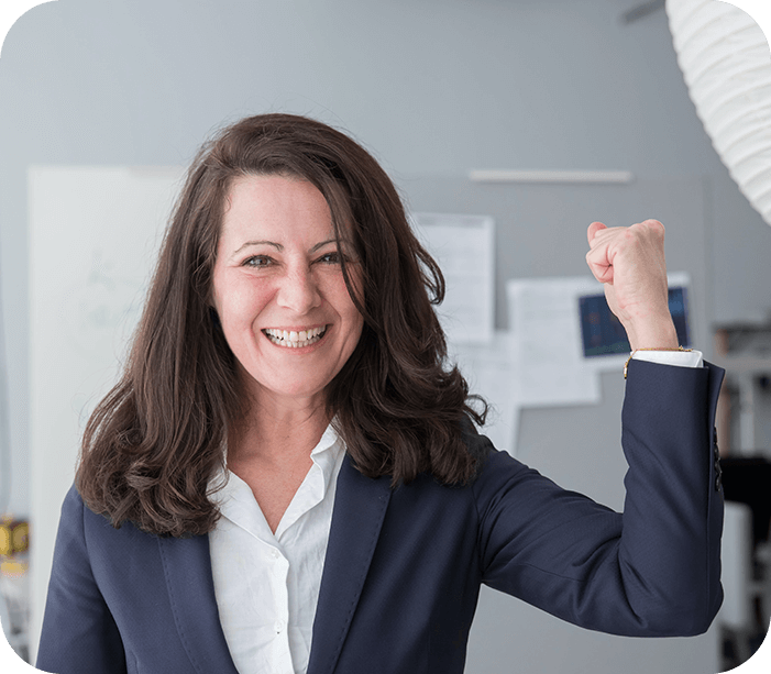 A woman in a suit raising her fist.