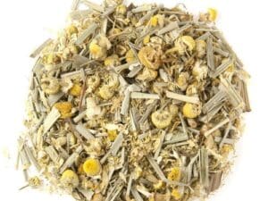 A pile of dried herbs and flowers on top of a white surface.